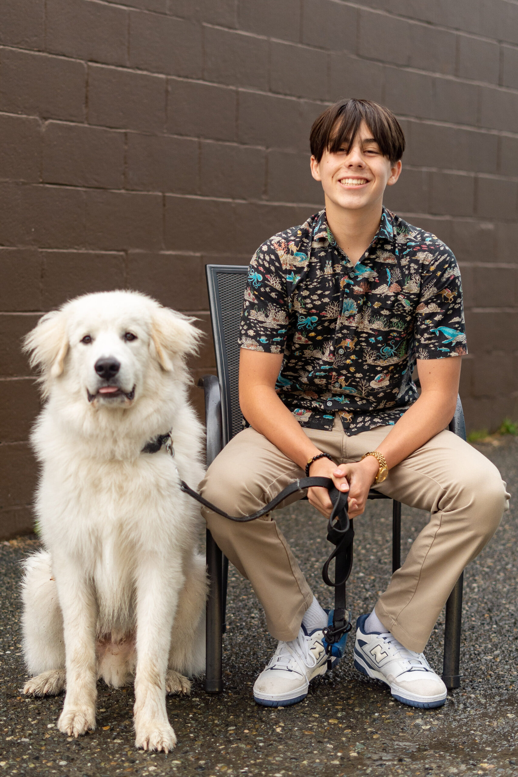 Ronin, a senior at Edmonds Woodway, sitting next to his dog during their senior photo session.