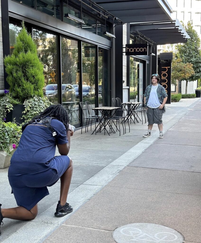 A senior boy from North Creek High School posing confidently in downtown Totem Lake during his senior photo session with the photographer.