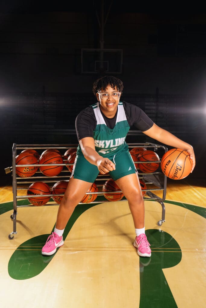 Close-up of a Skyline High senior basketball player dribbling during a photoshoot.