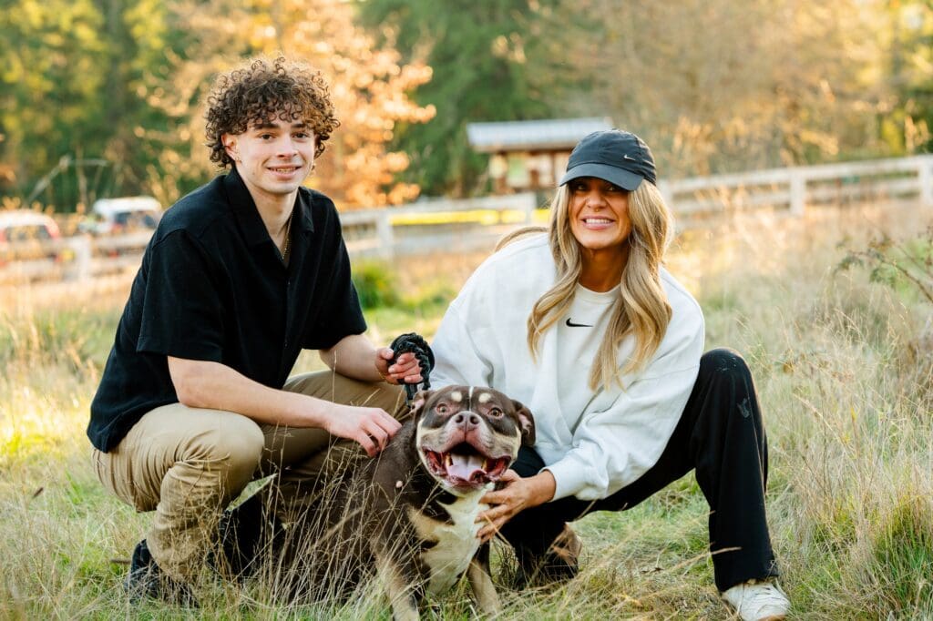 High school senior portrait of Mason, Mom and his dog in a field of tall grass in Sammamish WA.