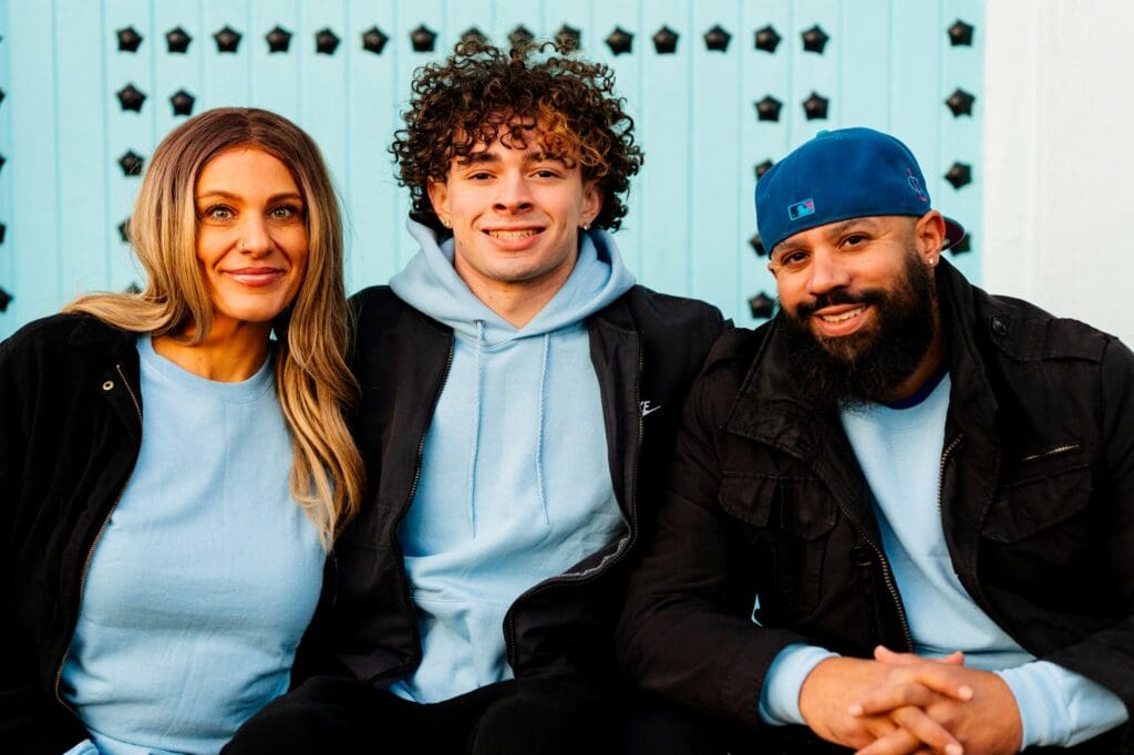 Mason and his family wearing matching sweatshirts for senior photos in downtown Issaquah by Last Forever Images.