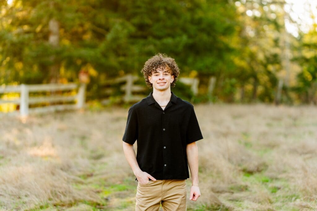 Lifestyle senior photography session in a field of tall grass during winter in WA.